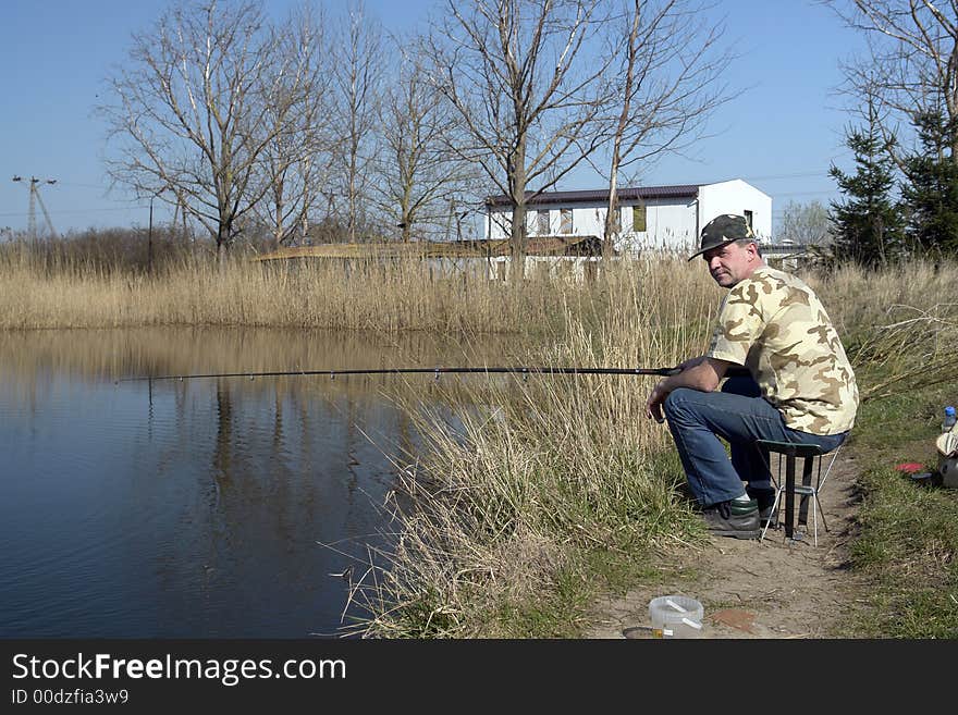 Old angler fishing on the lake. Old angler fishing on the lake