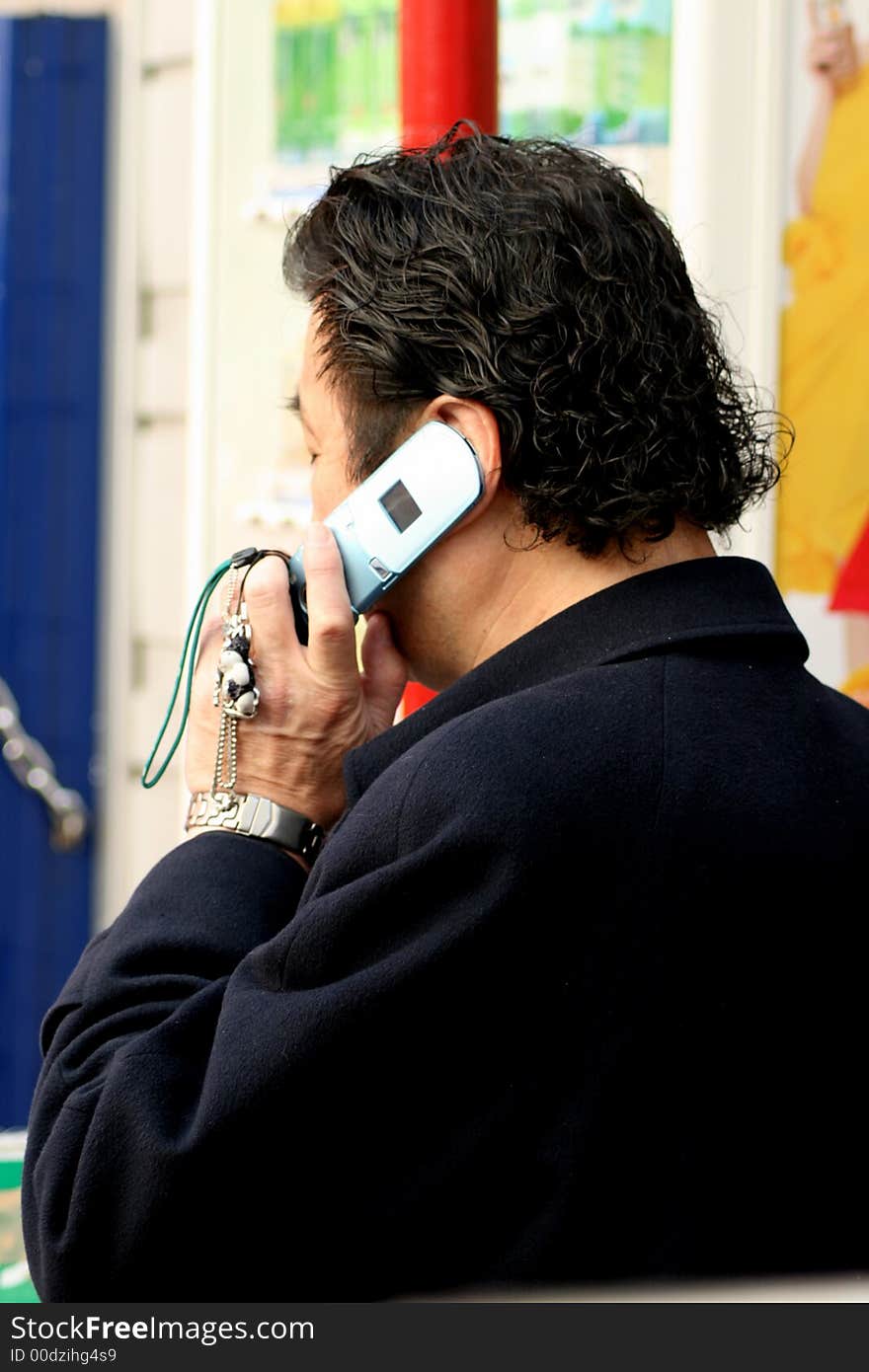 Man with dyed hair making a telephone call on cellular