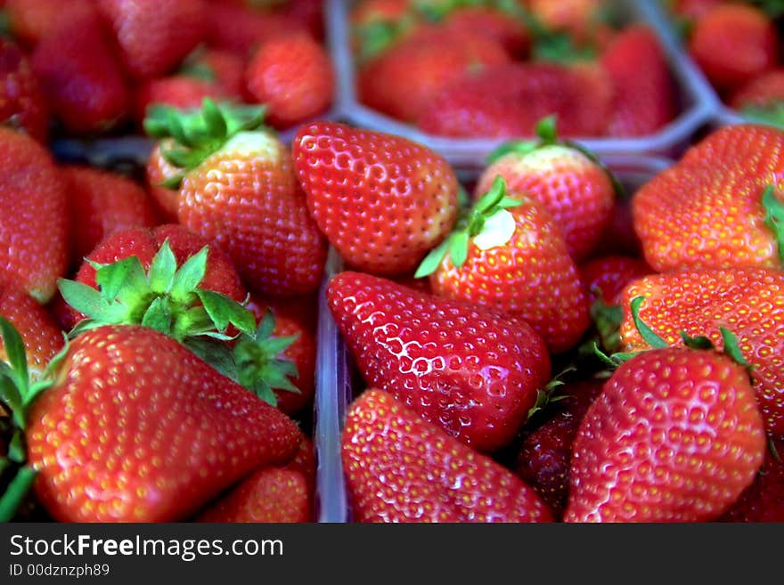 Red juicy Strawberries in market stand