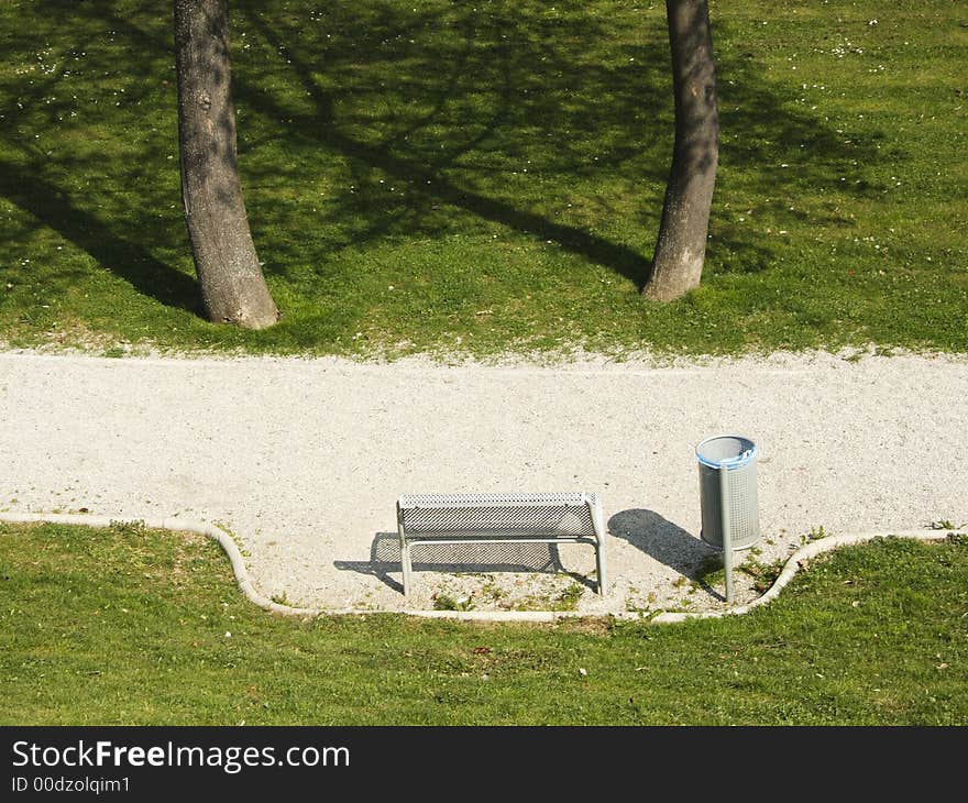 Empty park bench on the spring sunshine