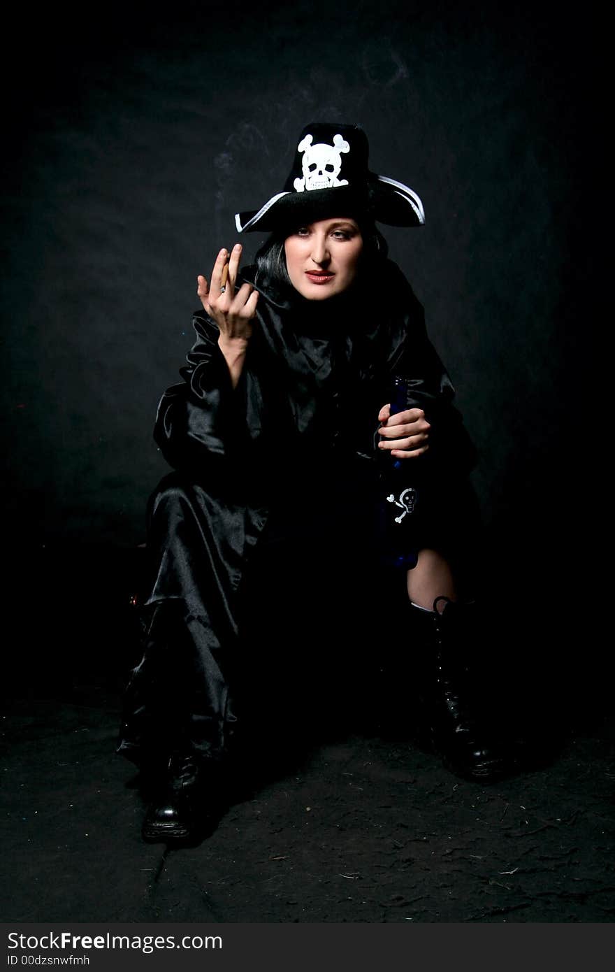 Women in pirate costume with bottle and cigarette. Make-up black background. Women in pirate costume with bottle and cigarette. Make-up black background.