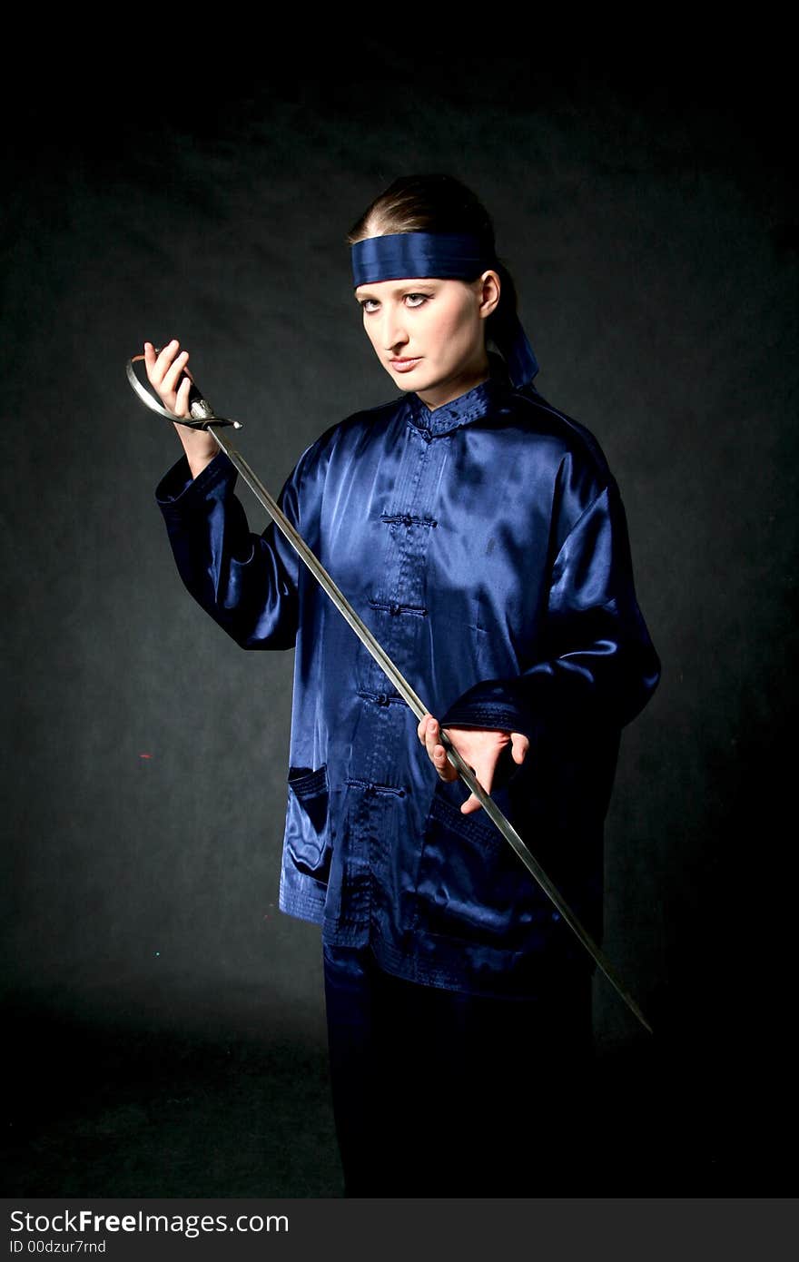 Women in chinese costume with epee: make-up. Women in chinese costume with epee: make-up