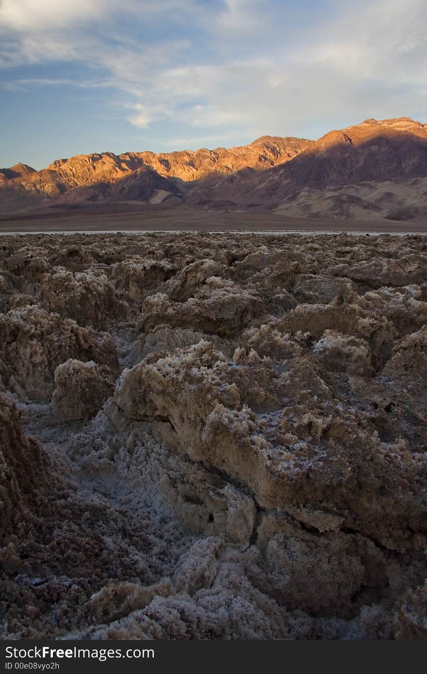 A scene of Devil's Golf Course in Death Vally Nation Park. The bottom bed is salt terrain from dried lake.