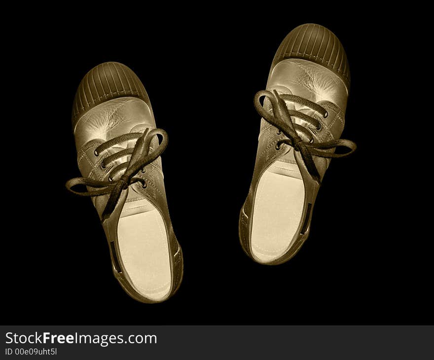 Golden shoes isolated on black background