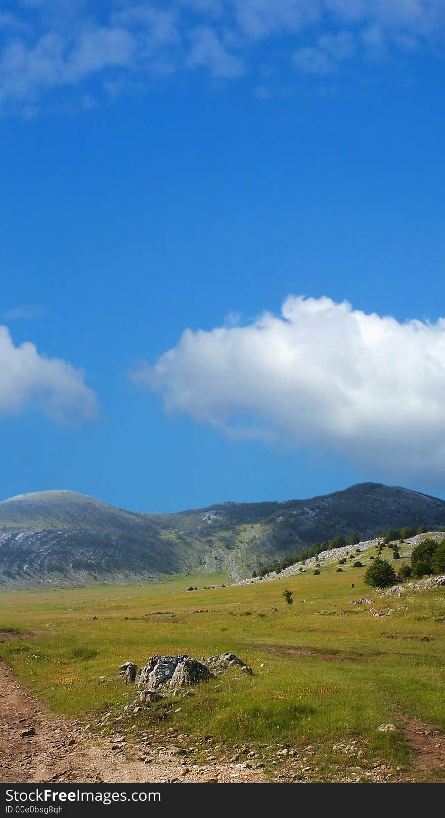 Dinara Mountain Over Blue Sky