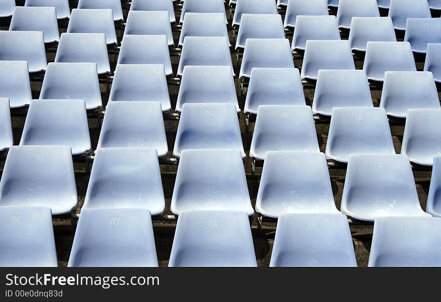 Many Empty Seats In Rows In An Outdoor Stadium. Many Empty Seats In Rows In An Outdoor Stadium