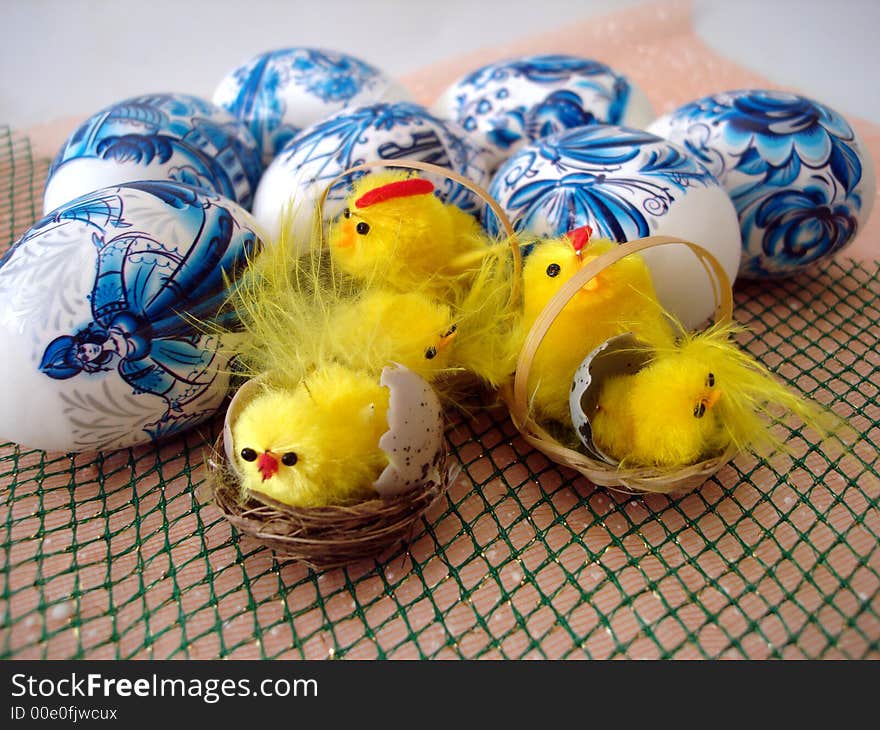 Many chicken on basket and blue easter eggs. Many chicken on basket and blue easter eggs