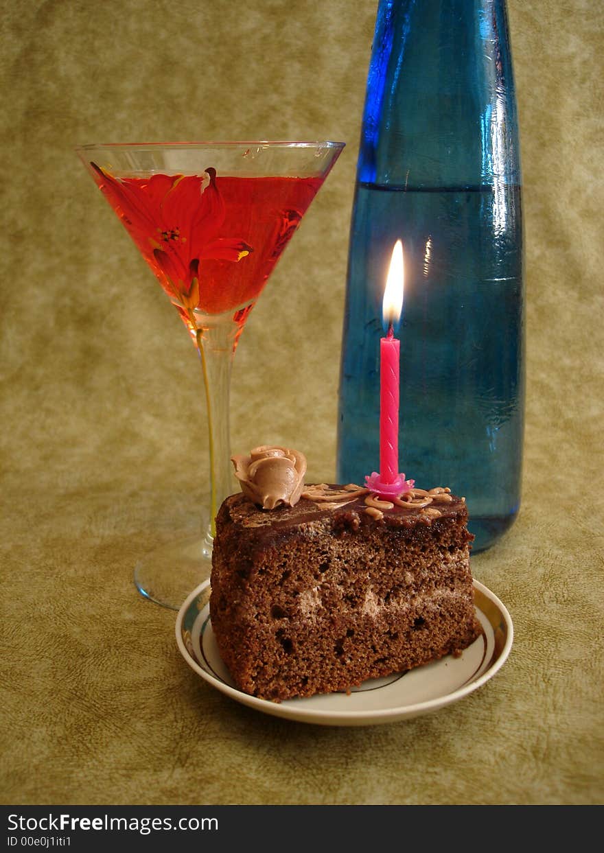 Celebratory table (Chocolate cake with red candle and blue bottle)