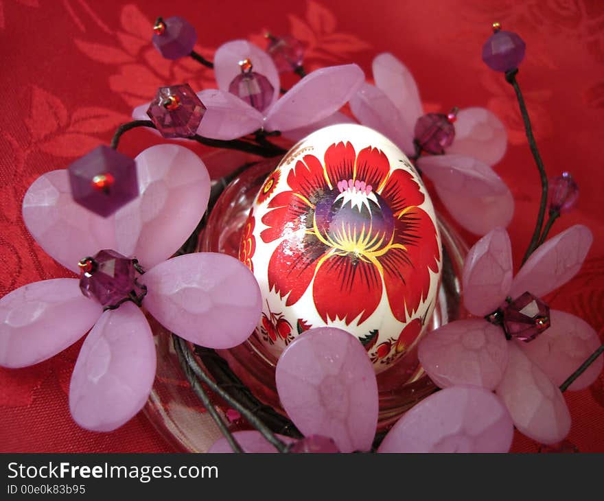 Beautiful easter egg and flower on red