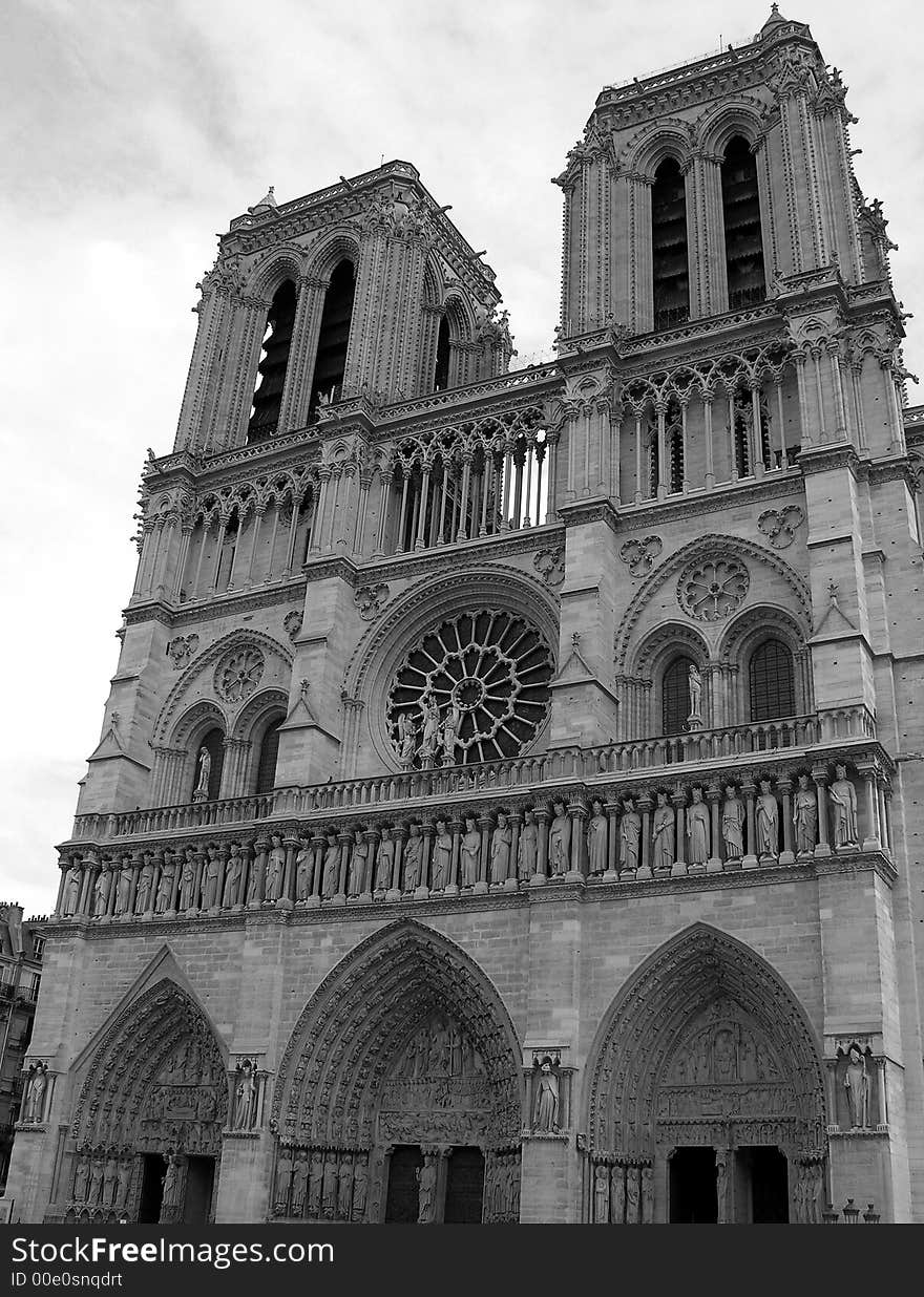 Black and white photograph of the facade of the famous cathedral of Notre Dame in Paris, France. Black and white photograph of the facade of the famous cathedral of Notre Dame in Paris, France.