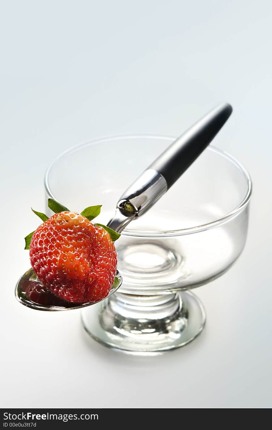 Delightful strawberry in strict laying on the spoon and a glass