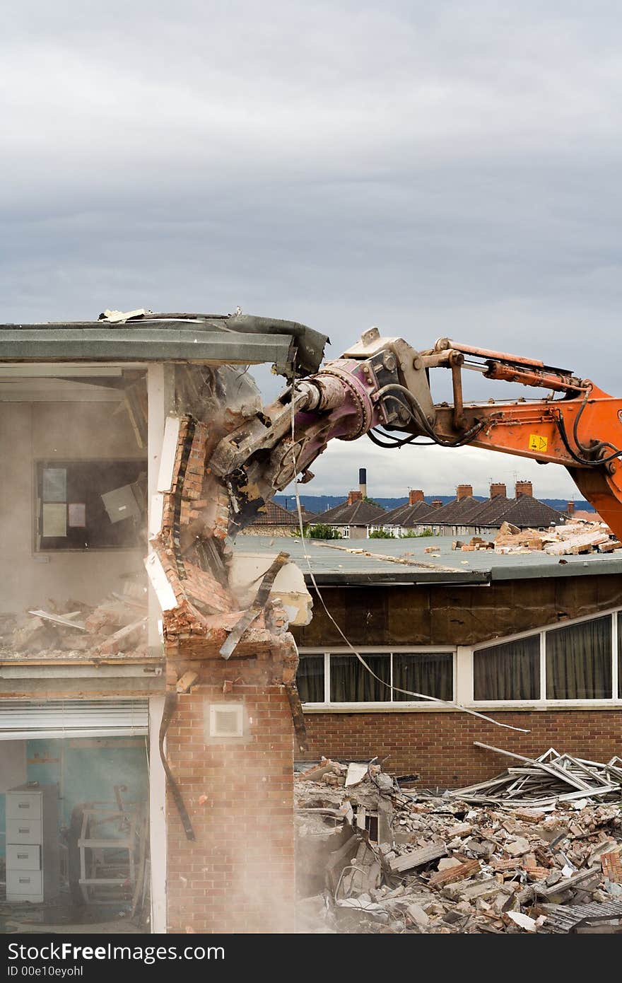 A machine knocks a building down. A machine knocks a building down