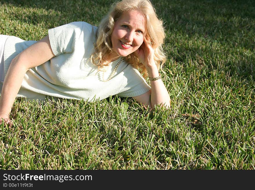 Shot of a woman laying in grass copyspace