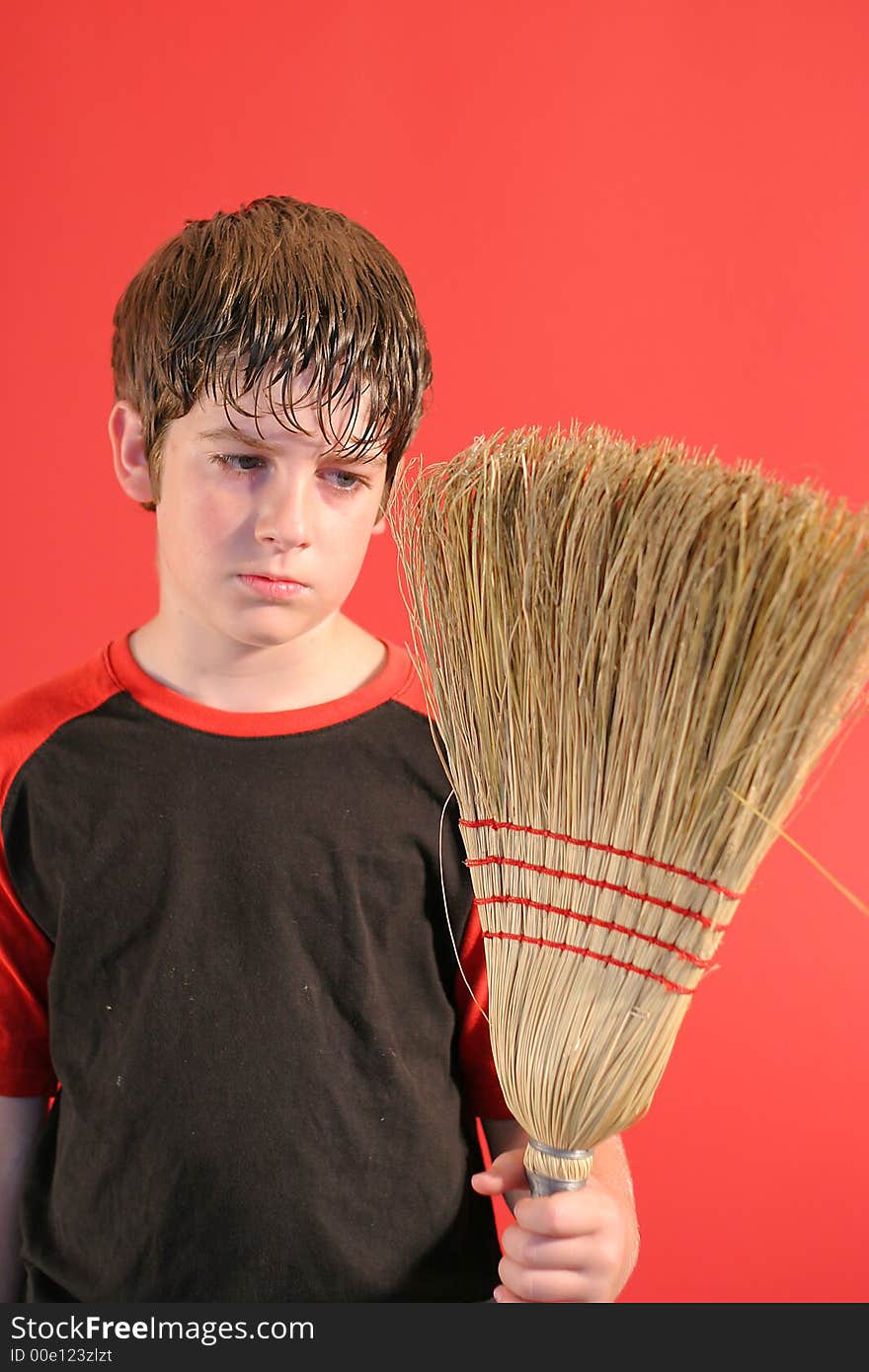 Shot of a mad boy with broom vertical