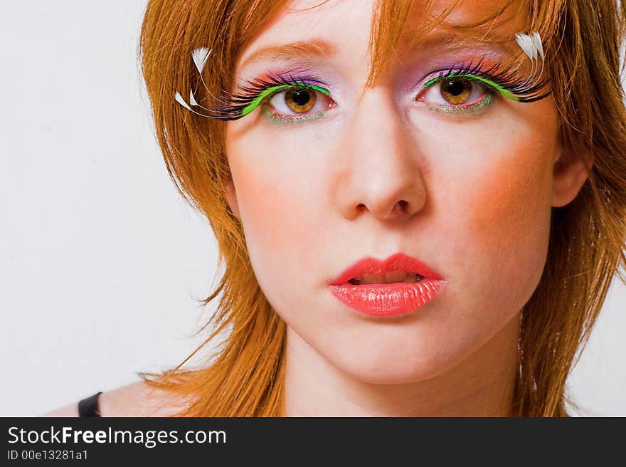 Portrait of a red haired girl with extreme make-up. Portrait of a red haired girl with extreme make-up