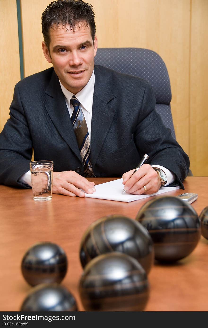 Businessman in a room writing on paper. Businessman in a room writing on paper