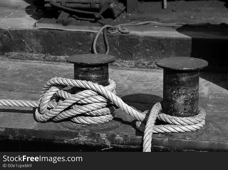 Mooring rope wrapped around two cleats on deck