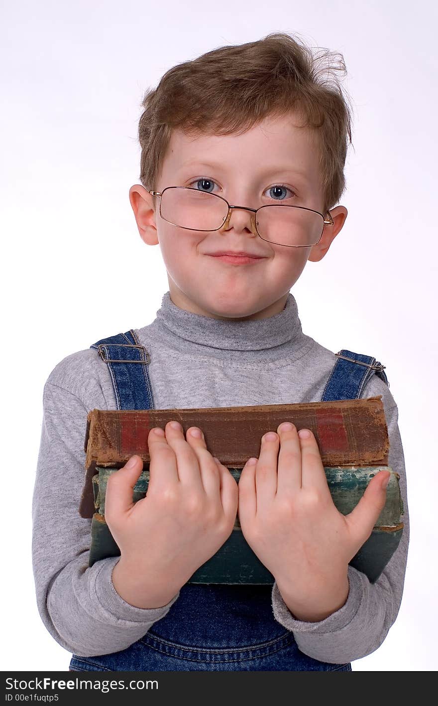 The boy in glasses and with books smiles on a white background. The boy in glasses and with books smiles on a white background