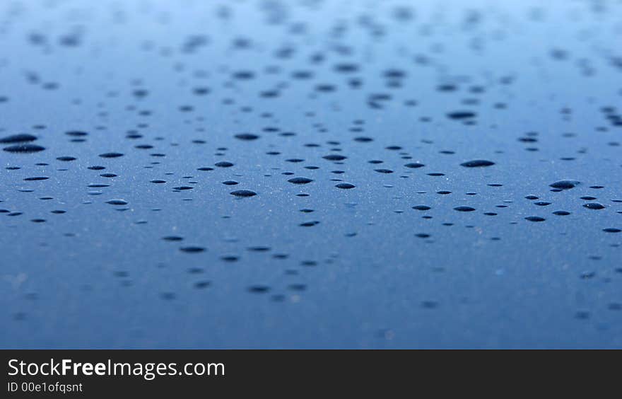 Closeup with selective focus on drop on a metallic surface. Closeup with selective focus on drop on a metallic surface