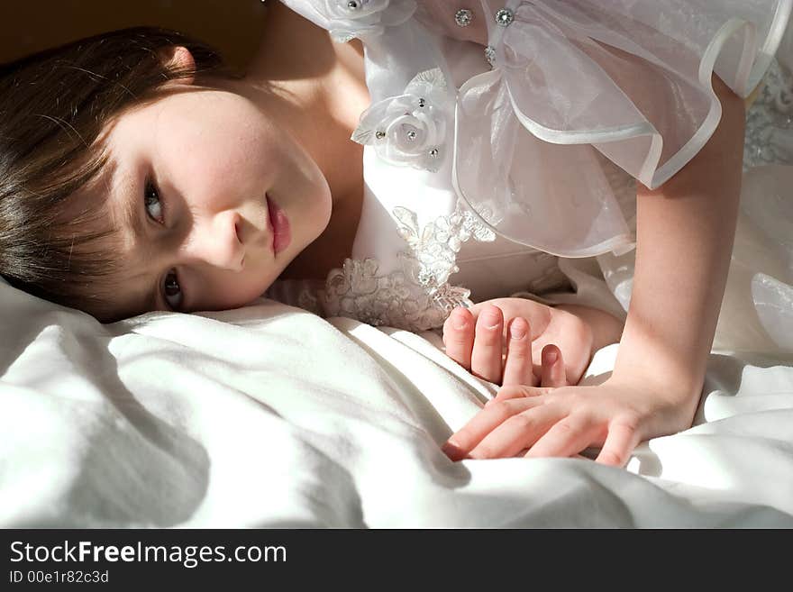 Portrait of beautiful young girl lying in the rays of sun. Portrait of beautiful young girl lying in the rays of sun