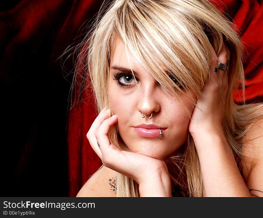 Beautiful blonde model with tattoos in studio. Beautiful blonde model with tattoos in studio