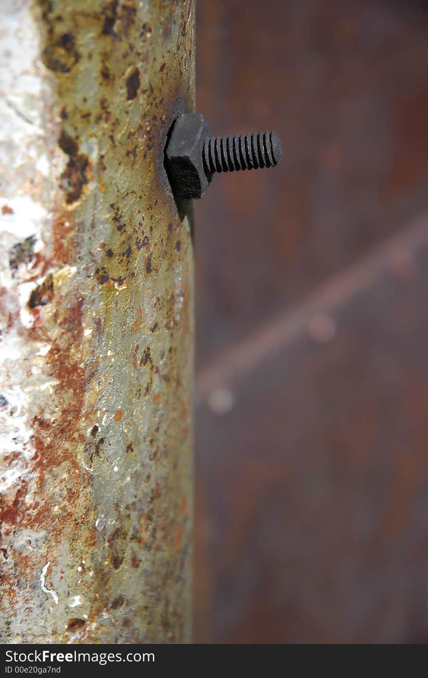 Detailed closeup of colorful rusty sheet of old metal and a bolt. Detailed closeup of colorful rusty sheet of old metal and a bolt