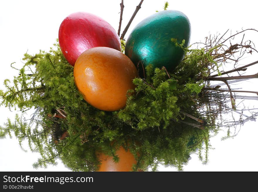 Coloured easter eggs in a jack from a moss and branches. Coloured easter eggs in a jack from a moss and branches