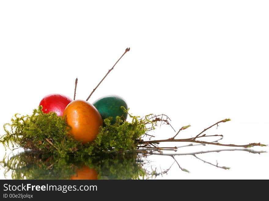 Coloured easter eggs in a jack from a moss and branches. Coloured easter eggs in a jack from a moss and branches