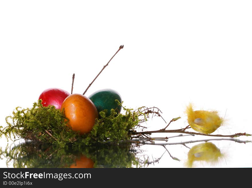 Coloured easter eggs in a jack from a moss and branches. Coloured easter eggs in a jack from a moss and branches