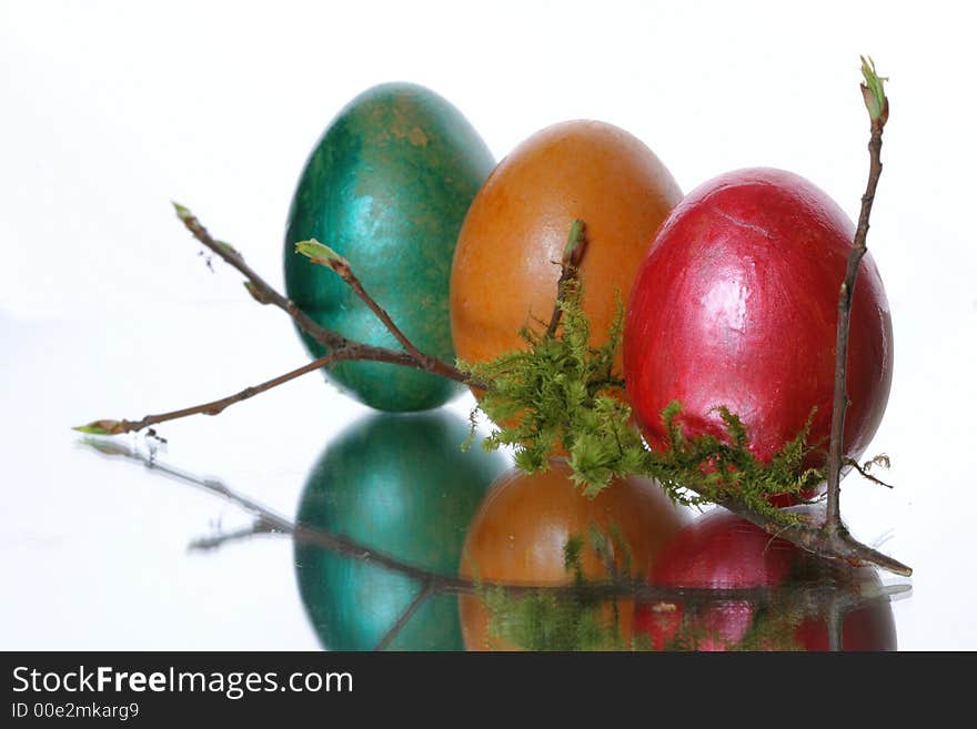 Colored easter eggs in a jack from a moss and branches