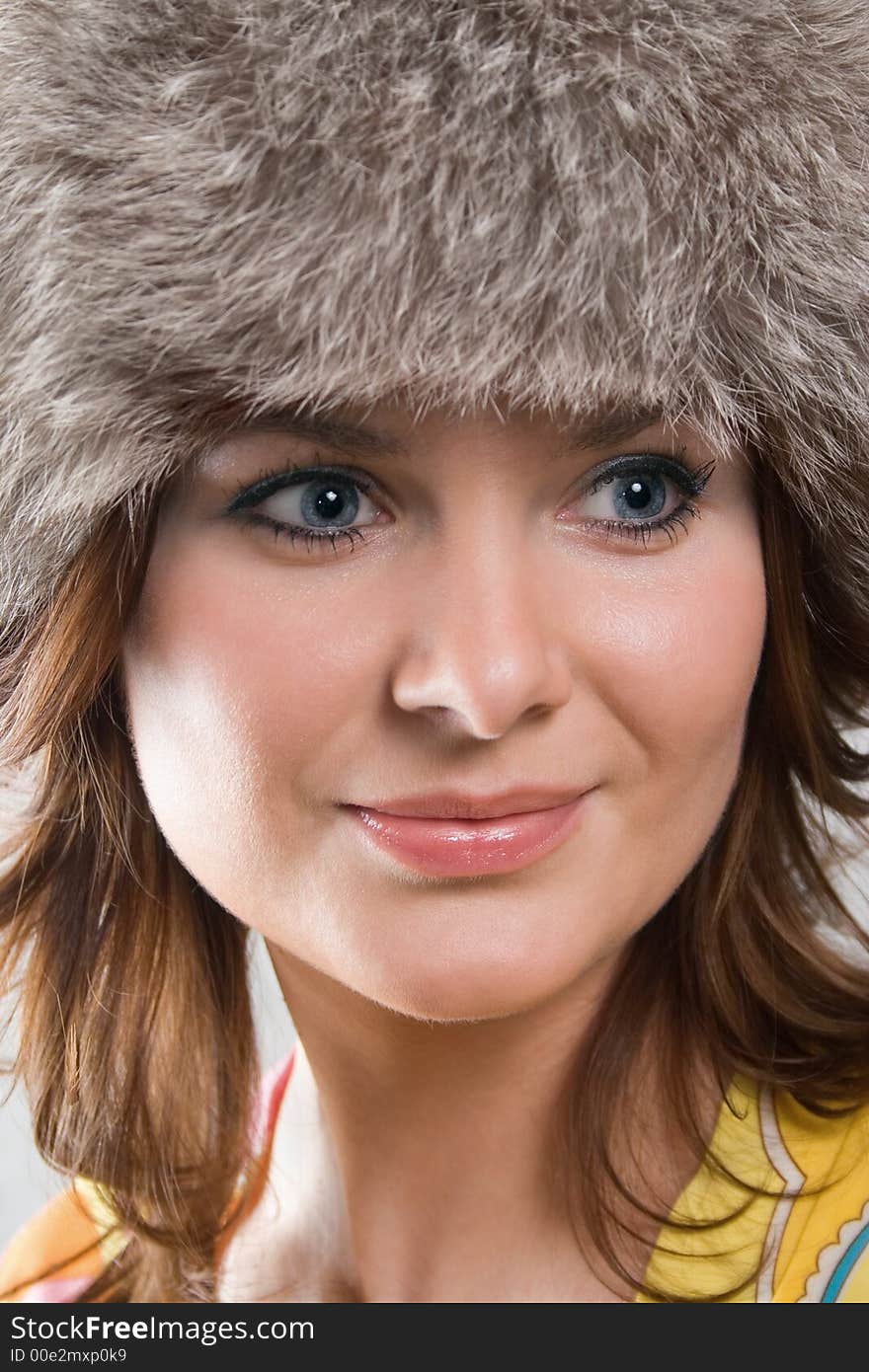 Portrait of a white beautiful woman in a fur hat. Portrait of a white beautiful woman in a fur hat