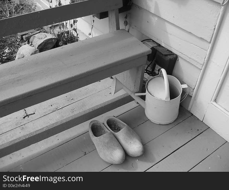 Wooden shoes and watering can