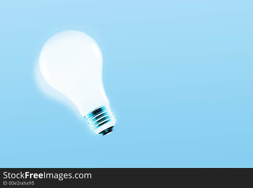 Glowing light bulb on a light blue background