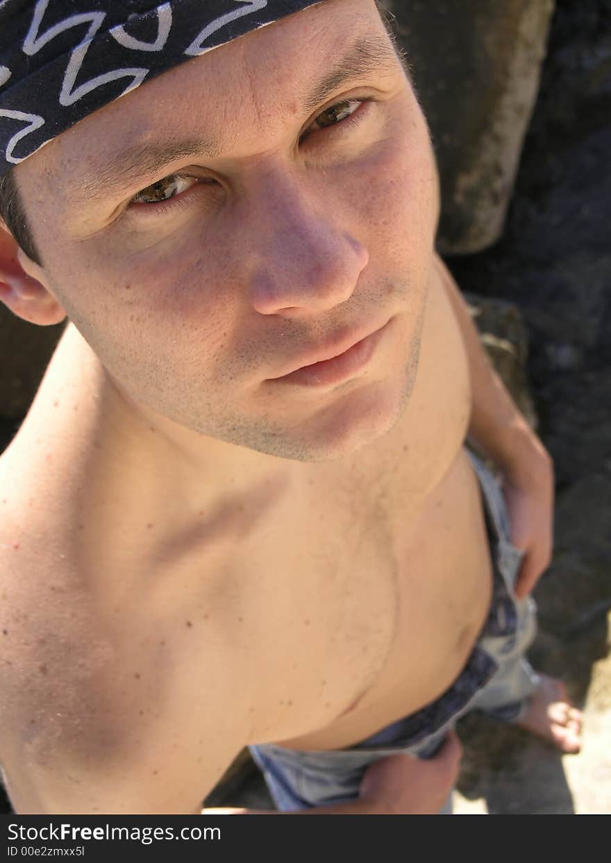 Young man with kerchief at the beach. Young man with kerchief at the beach.