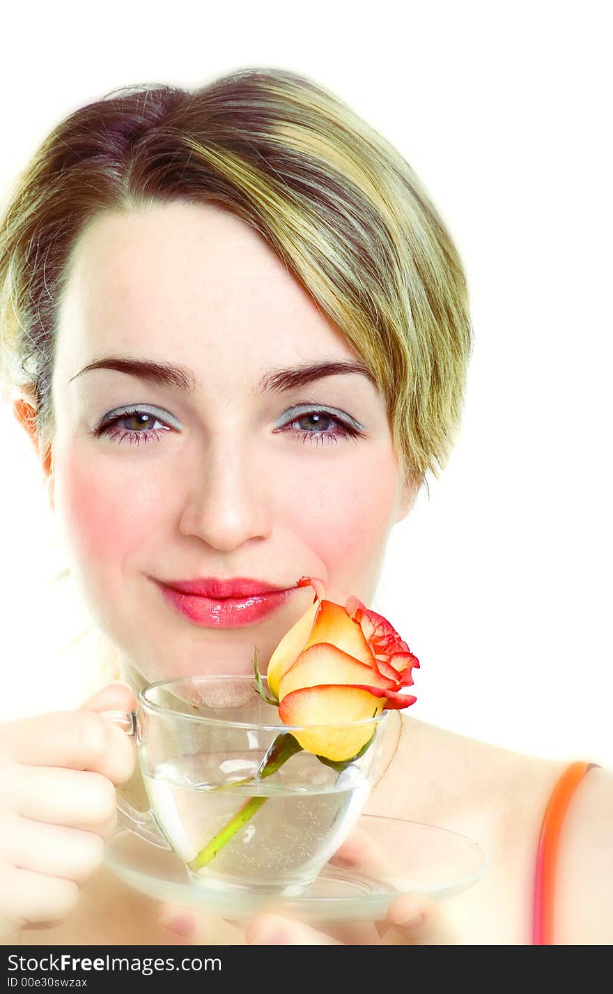 Smiling girl with rose in the cup