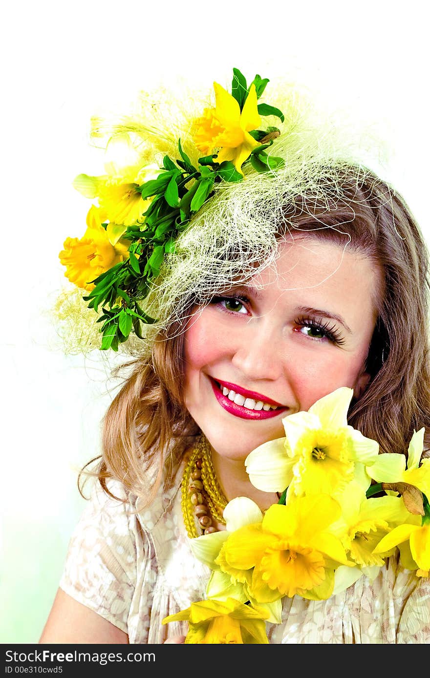 Beautiful smiling girl with narcissus in her hair