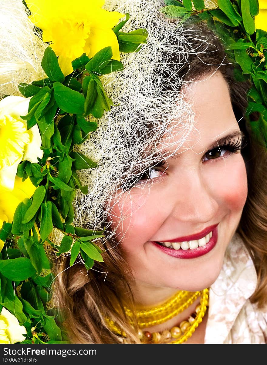 Beautiful smiling girl with narcissus in her hair