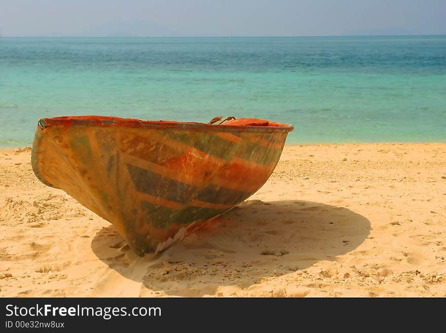 The old thrown boat on a beach in Phuket