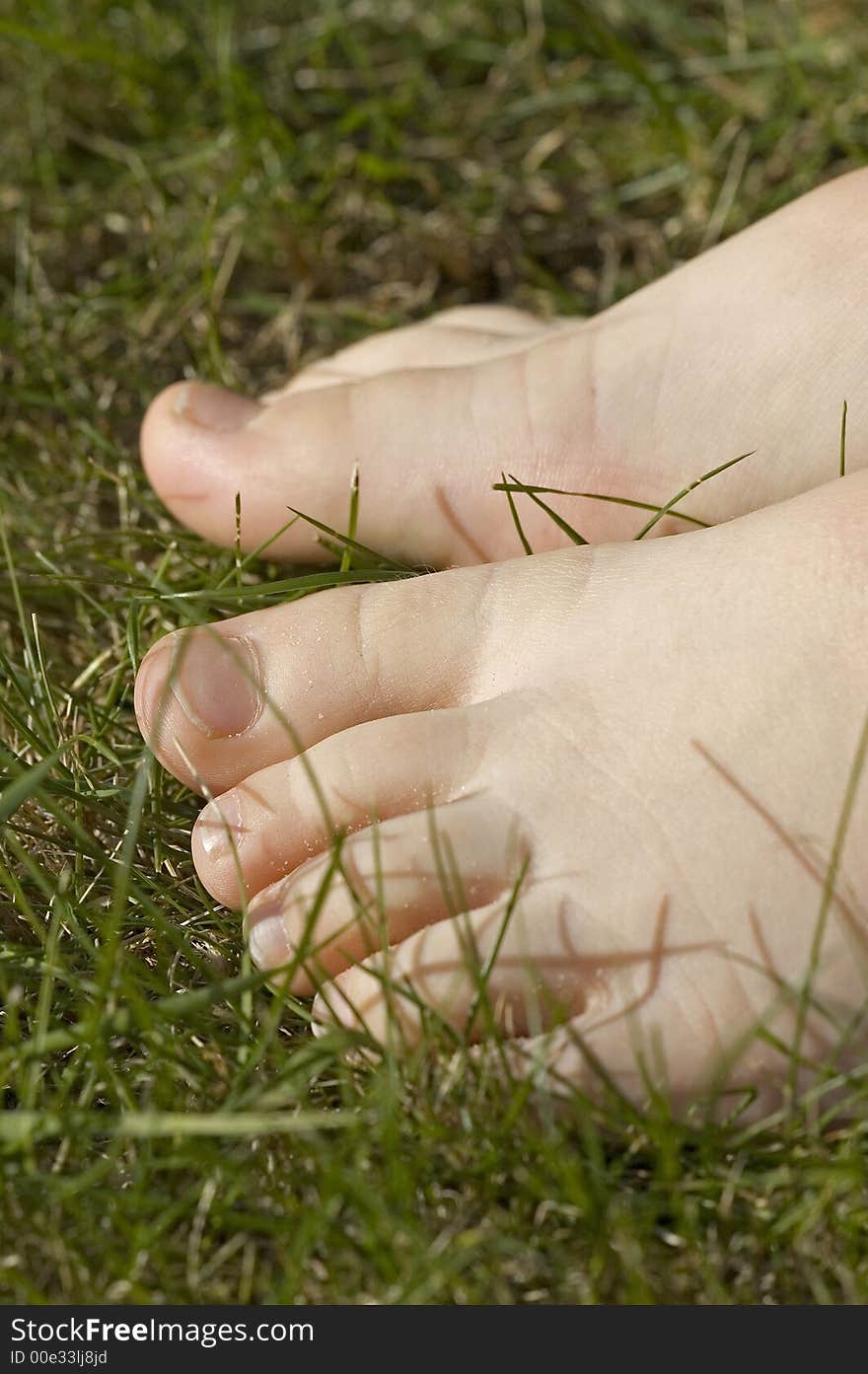 Child walking barefoot in grass