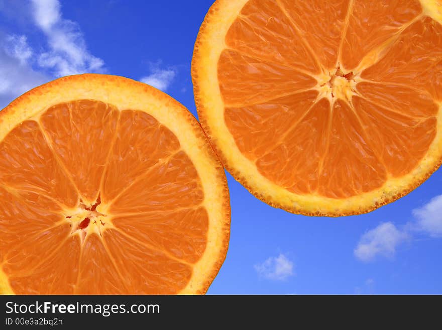 Close-up of oranges on blue sky