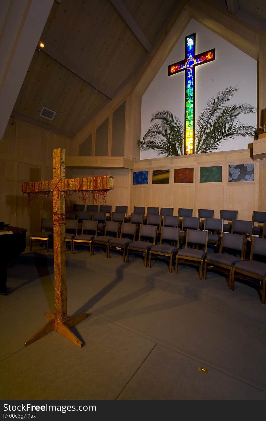 Shot of a stained glass cross in a Christian Church decorated for Easter.