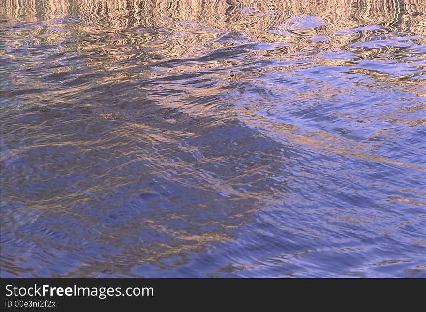 Reflection of heavenly, blue light in waves on  surface of water. Reflection of heavenly, blue light in waves on  surface of water