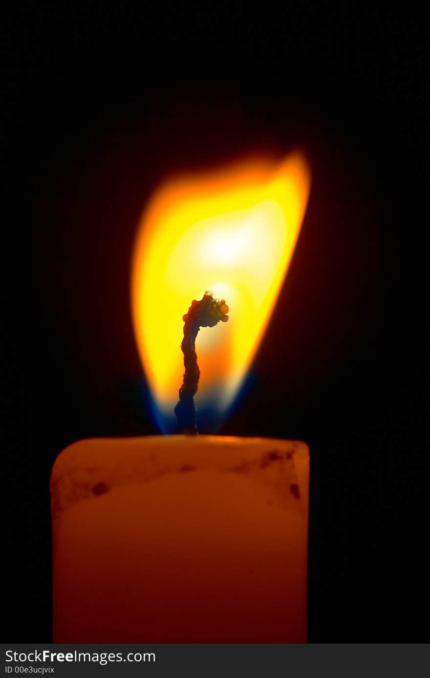 Romantic burning candle on black background