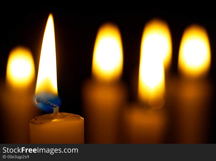 Romantic burning candles on black background