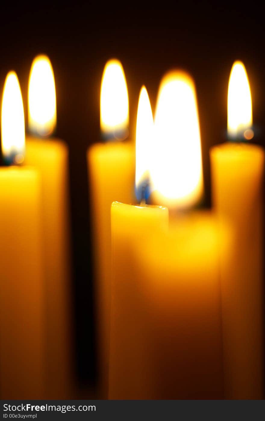 Romantic burning candles on black background