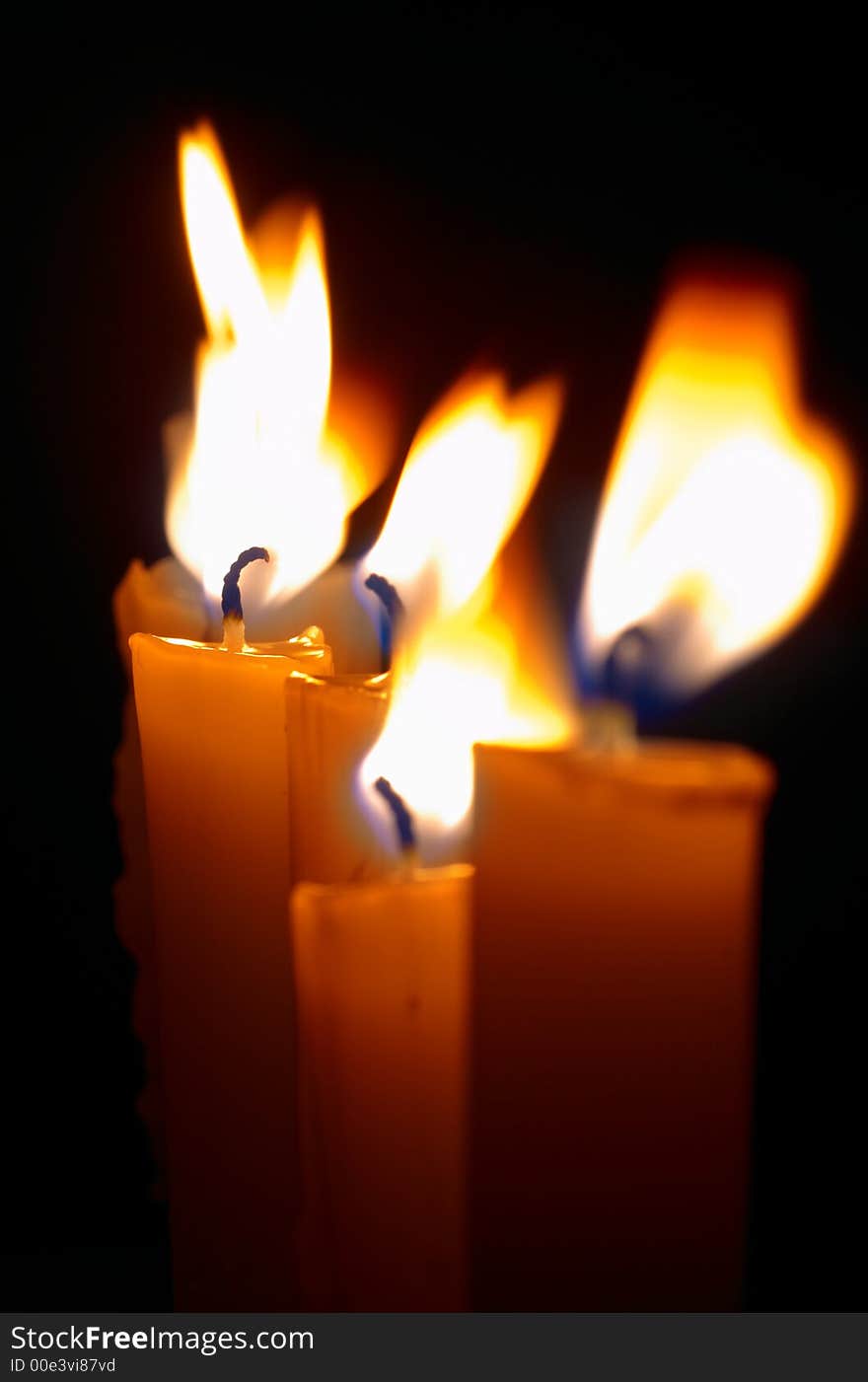 Romantic burning candles on black background