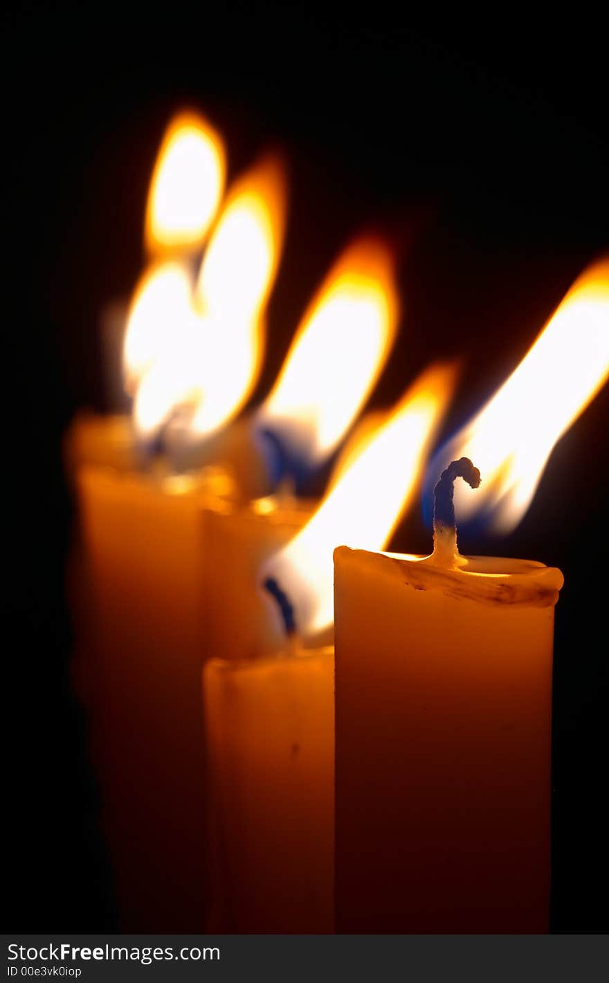 Romantic burning candles on black background