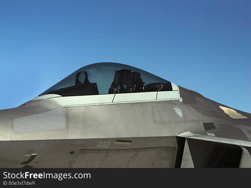 A military jet on the tarmac. The cockpit is empty. A military jet on the tarmac. The cockpit is empty.