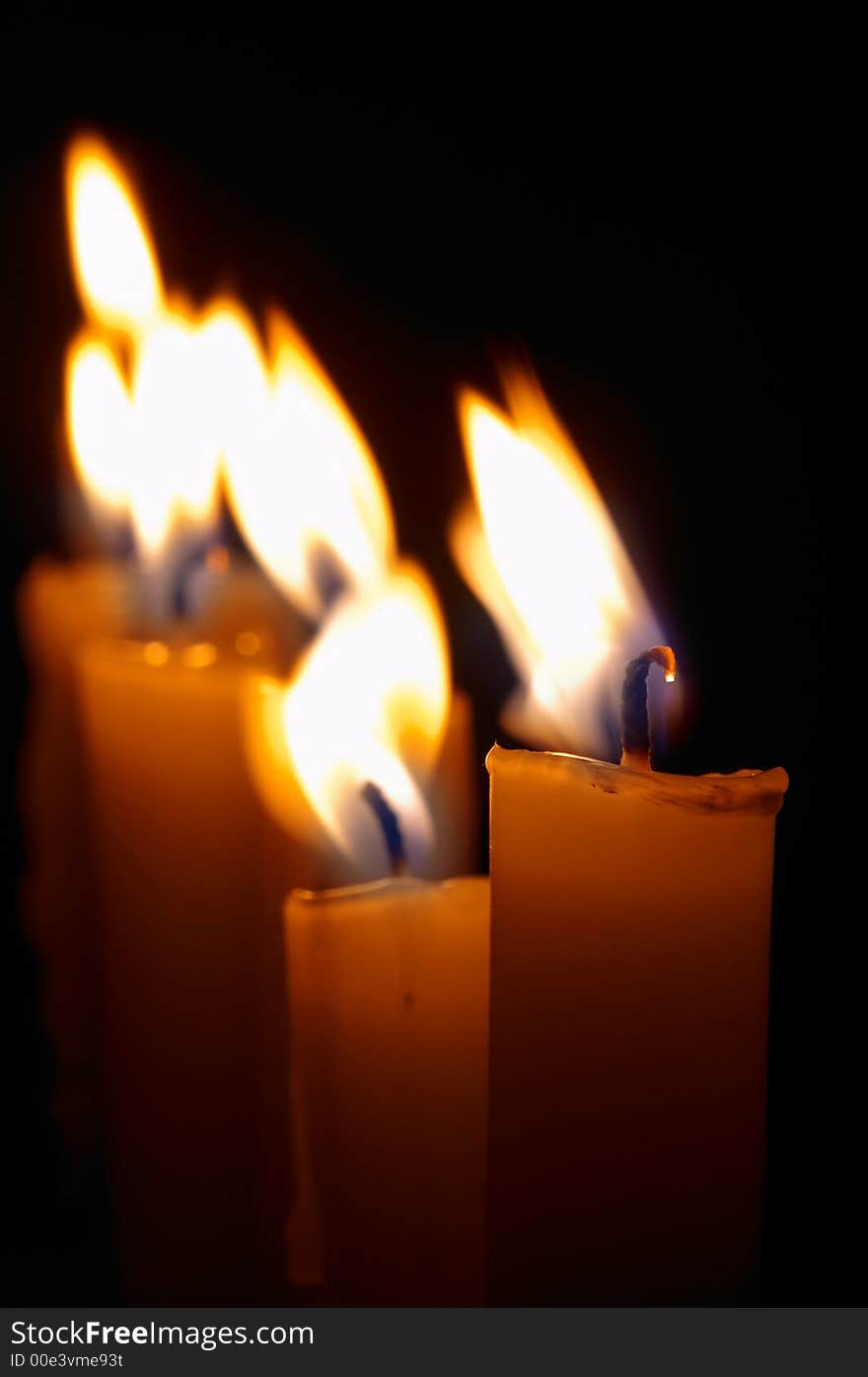 Romantic burning candles on black background