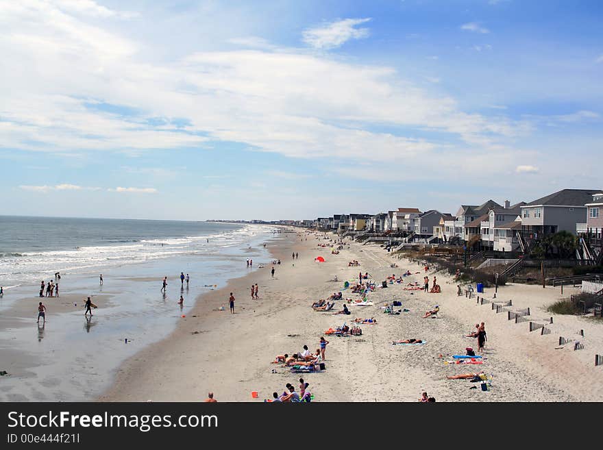 Overhead view of the beach with people having fun and beach houses. Overhead view of the beach with people having fun and beach houses